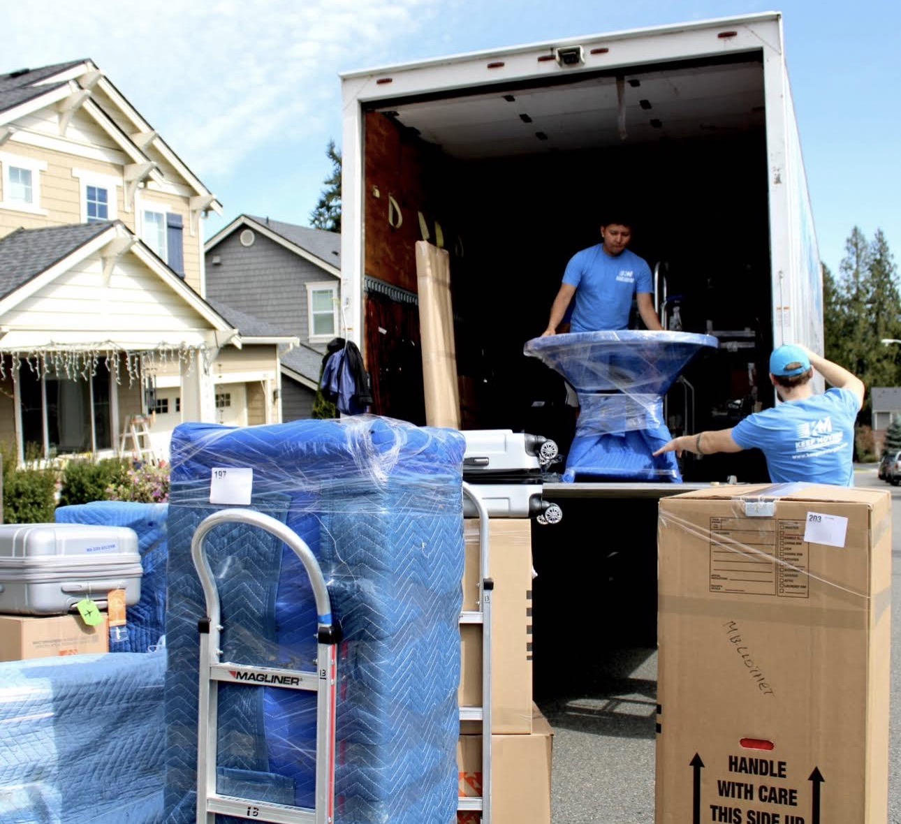Professional house movers in Toronto loading household furniture onto a moving truck