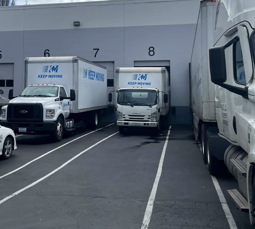 Keep Moving Brampton movers loading boxes onto a moving truck