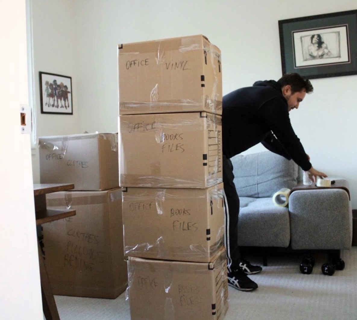 Keep Moving mover stands among labeled cardboard moving boxes during a Toronto to Buffalo cross-border move
